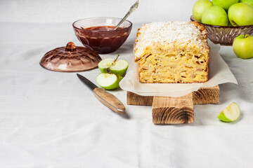Apple and coconut loaf cake on wooden cutting board