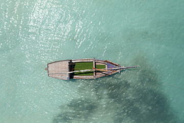 Tropical island of Zanzibar, Tanzania. Lonely fishing boat in azure water