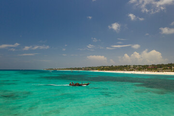 Tropical island of Zanzibar, Tanzania. The fishing boat is sailing to the shore