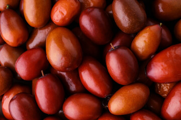 Heap of ripe red dates as background, closeup