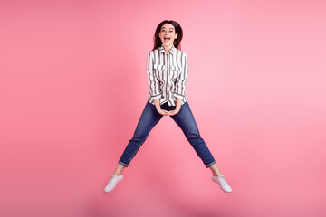 Fototapeta na wymiar Full body photo of attractive pretty woman good mood jumper air fly isolated over pink color background