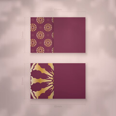 Burgundy business card with Greek gold ornaments for your business.