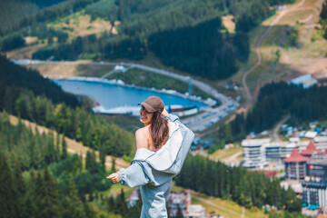 portrait of smiling woman tourist at mountain peak