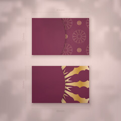 Burgundy business card with Greek gold ornaments for your contacts.