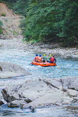 people rafting at mountain river