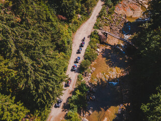 aerial view of quad bike riders at mountain trail road