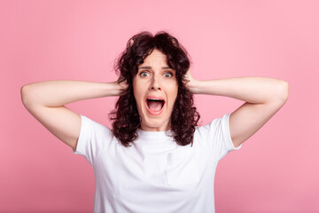Photo of young woman arms touch head crazy omg unexpected scared isolated over pink color background