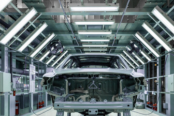 Car bodies are on assembly line. Factory for production of cars. Modern automotive industry