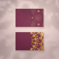 Burgundy business card with mandala gold ornament for your contacts.
