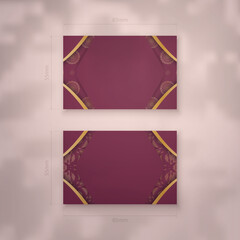 Burgundy business card with vintage gold pattern for your brand.