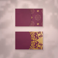 Burgundy business card with vintage gold pattern for your contacts.