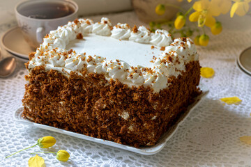 Honey cake. Layered honey cake decorated with cream.