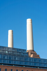 Fototapeta na wymiar Chimneys of Battersea Power station against blue sky, London, UK