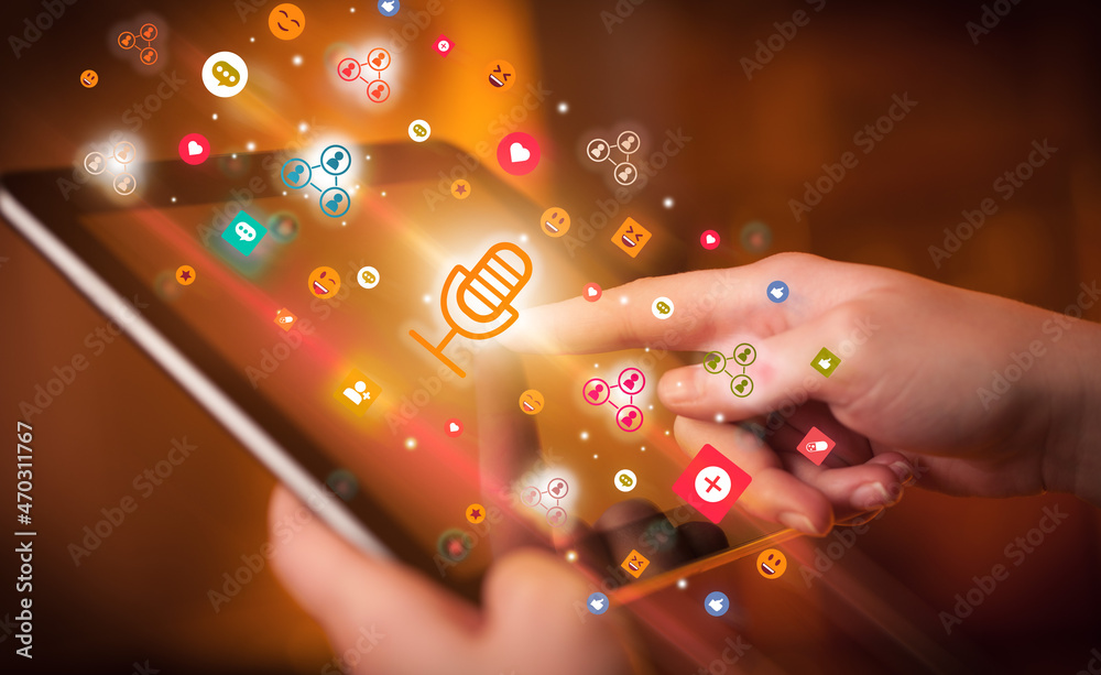 Poster close-up of a hand using tablet with social media icons