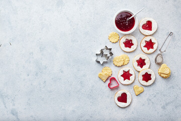 Classic Linzer Christmas Cookies with raspberry or strawberry jam on light background.