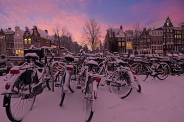 Naklejka premium City scenic from snowy Amsterdam in the Netherlands at sunset