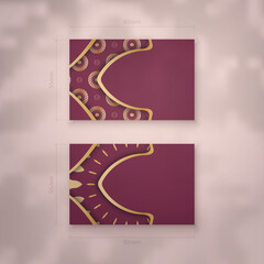 Business card in burgundy color with luxurious gold pattern for your brand.
