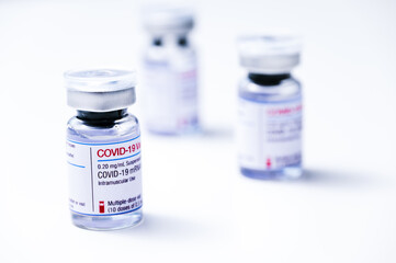Coronavirus vaccine, COVID-19 vaccine, corona vaccination. Vials of mRNA vaccine for injection on a white background.