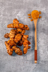 A high angle view of turmeric root and powder