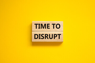 Time to disrupt symbol. Concept words Time to disrupt on wooden blocks on a beautiful yellow...
