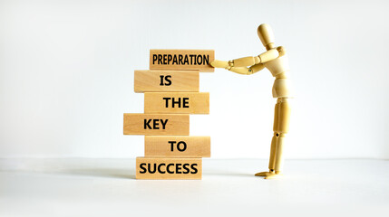 Preparation and success symbol. Wooden blocks with words Preparation is the key to success on on a beautiful white background, copy space. Businessman model. Business, preparation and success concept. - obrazy, fototapety, plakaty