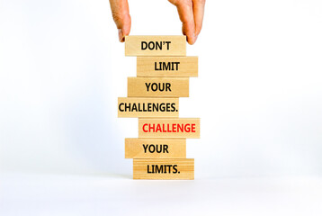 Do not limit your challenges symbol. Wooden blocks with words Do not limit your challenges. Challenge your limits. Beautiful white background, copy space. Businessman hand. Business concept.