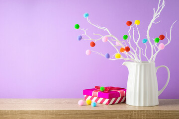 Christmas holiday creative decoration on wooden shelf over violet background with copy space