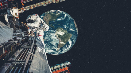 Astronaut spaceman do spacewalk while working for spaceflight mission at space station . Astronaut wear full spacesuit for operation . Elements of this image furnished by NASA space astronaut photos . © InfiniteFlow