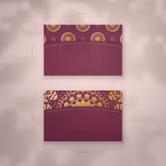 Business card template burgundy with vintage gold ornaments for your business.