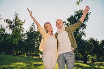 Photo of cheerful happy people old couple raise hands anniversary nature summer outside outdoors in park