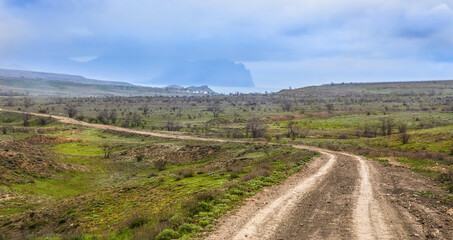 Dirt winding road to the village by the sea
