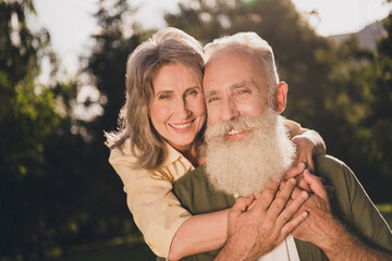 Photo of sweet old couple hug wear casual shirt walk in garden outside outdoors