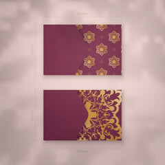 Business card template in burgundy color with abstract gold ornaments for your personality.