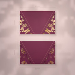 Business card template in burgundy color with an abstract gold pattern for your contacts.