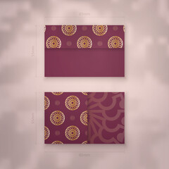 Business card template in burgundy color with Greek gold ornaments for your contacts.