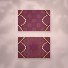 Business card template in burgundy color with Indian gold ornaments for your personality.