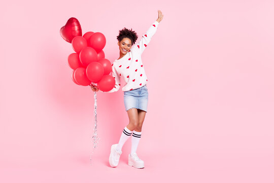Full body photo of young excited african lady inflate many balloons decor festive isolated over pink color background