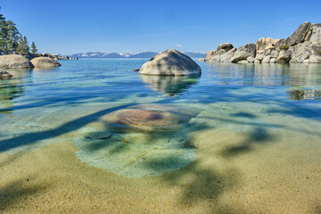 The beautiful clear waters and granite boulders of Lake Tahoe on the Nevada and California border