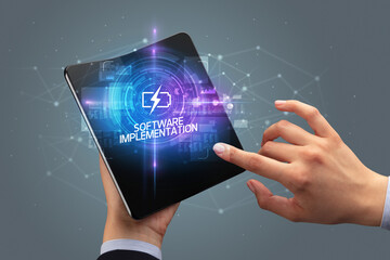 Businessman holding a foldable smartphone, technology concept