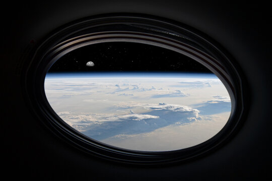 Space tourism. View of the Earth from a spaceship. Photomontage. Elements of this image furnished by NASA.