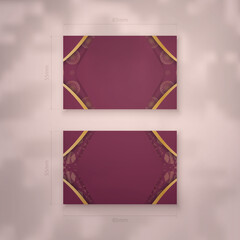 Business card template in burgundy color with luxurious gold pattern for your brand.