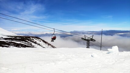 Ski lift reaching the top of Osorno Volcano above the clouds, southern Chile, Patagonia.
