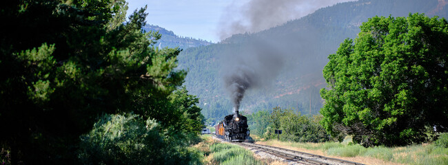 Panoramic image of The narrow gauge railroad locomotive under power between Durango and Silverton in Colorado