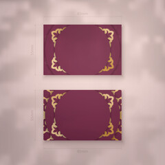 Business card template in burgundy color with vintage gold ornaments for your personality.