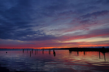 Fototapeta na wymiar Sunrise on Rockland Harbor in Maine with calm oily waters