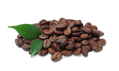 Pile of roasted coffee beans with fresh leaves on white background