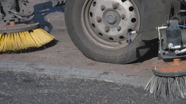 A street sweeper car cleaning the streets.