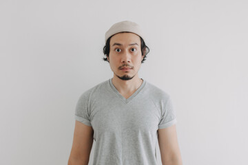 Long hair and beard Asian man in grey t-shirt and cap isolated on white.