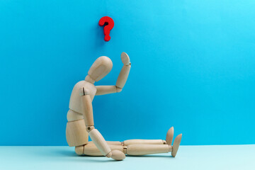 Wooden mannequin dummy figure and question mark, confusion and asking question concept.