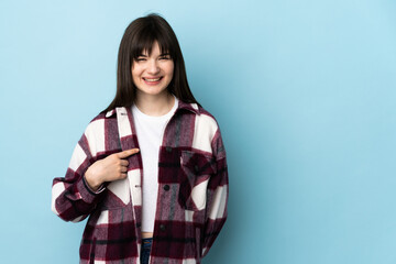 Teenager Ukrainian girl isolated on blue background with surprise facial expression